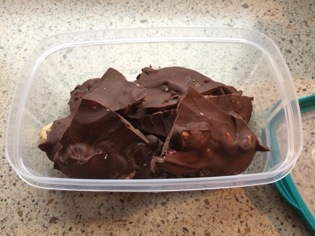 a container of broken pieces of chocolate bark.