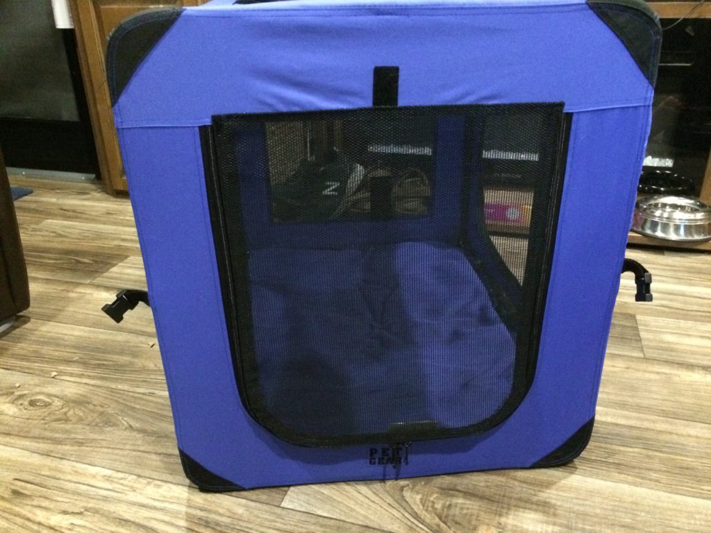 The finished replaced screen on a zippered side of the pet crate.