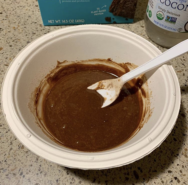 unbaked cake mix in a bowl with a spoon.