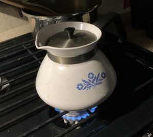 a teapot on a propane stove.