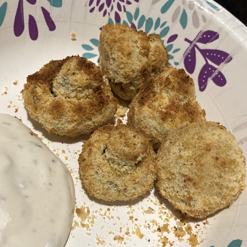 Breaded mushrooms with a dollop of ranch dip  
