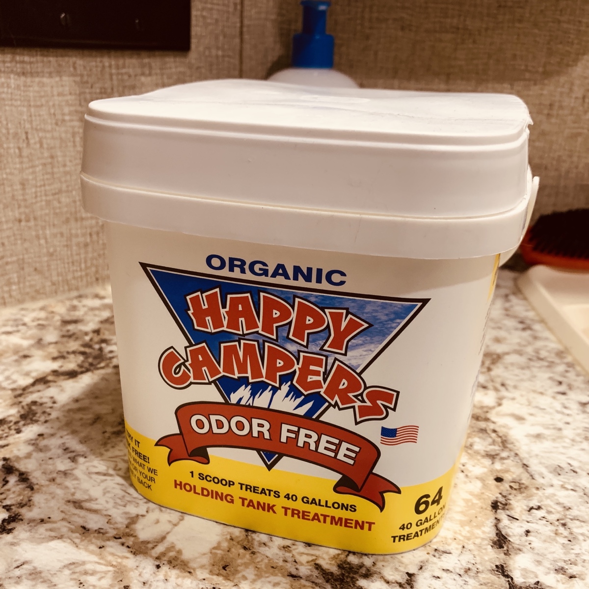 a large tub of Happy Campers holding tank treatment on a bathroom counter.