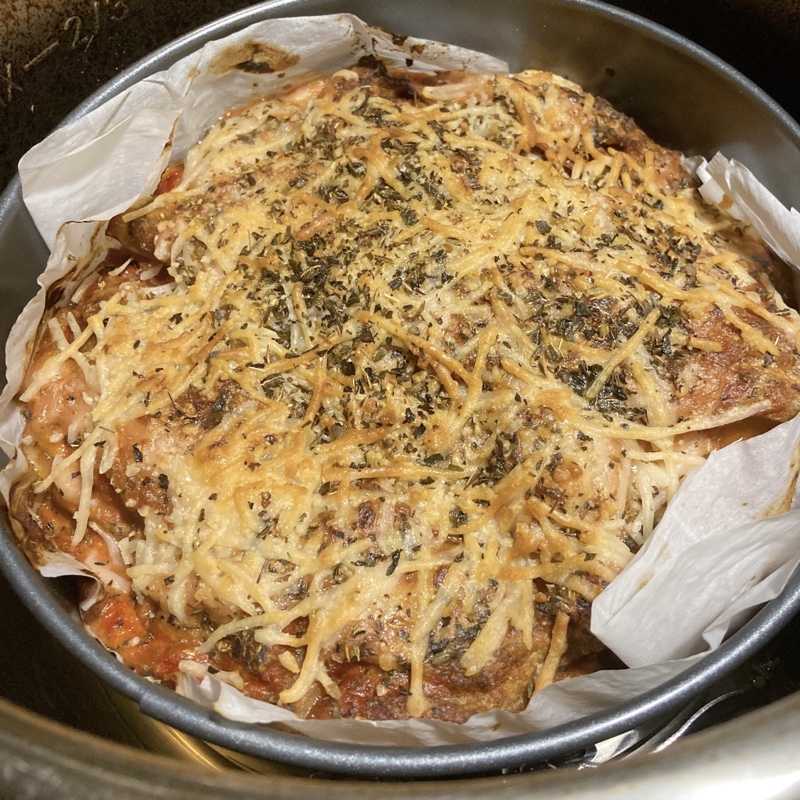 baked and browned lasagna in a round pan