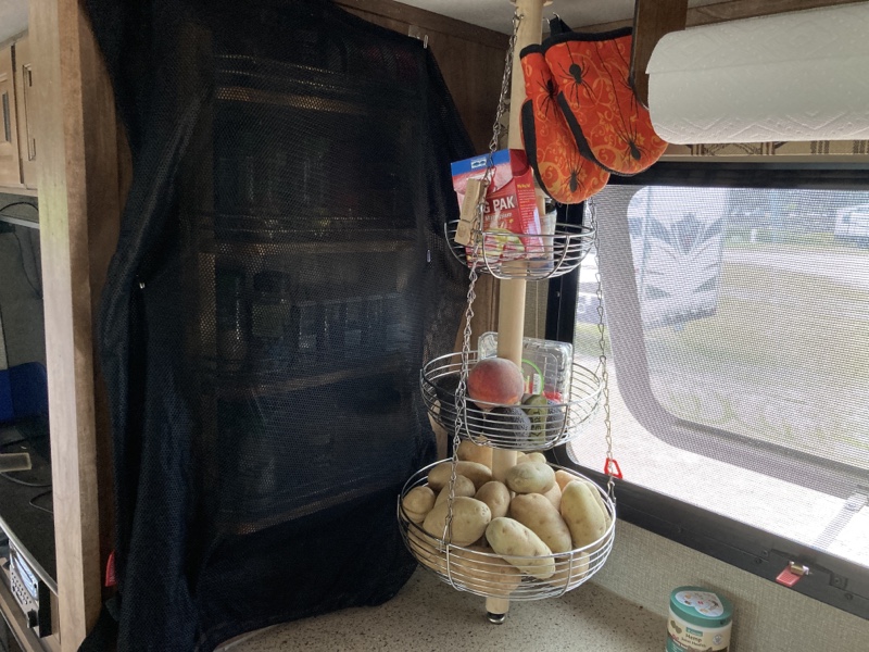 The spice rack with black fabric covering it. 